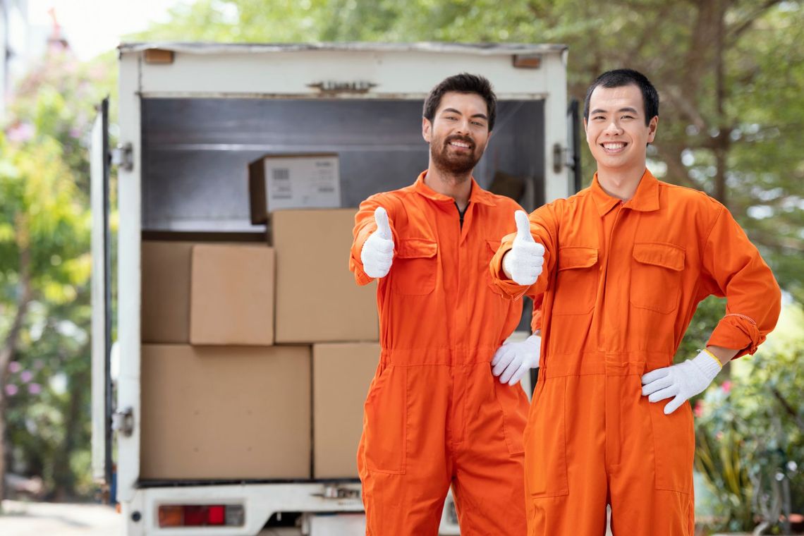 two men in orange jumpsuits are giving a thumbs up