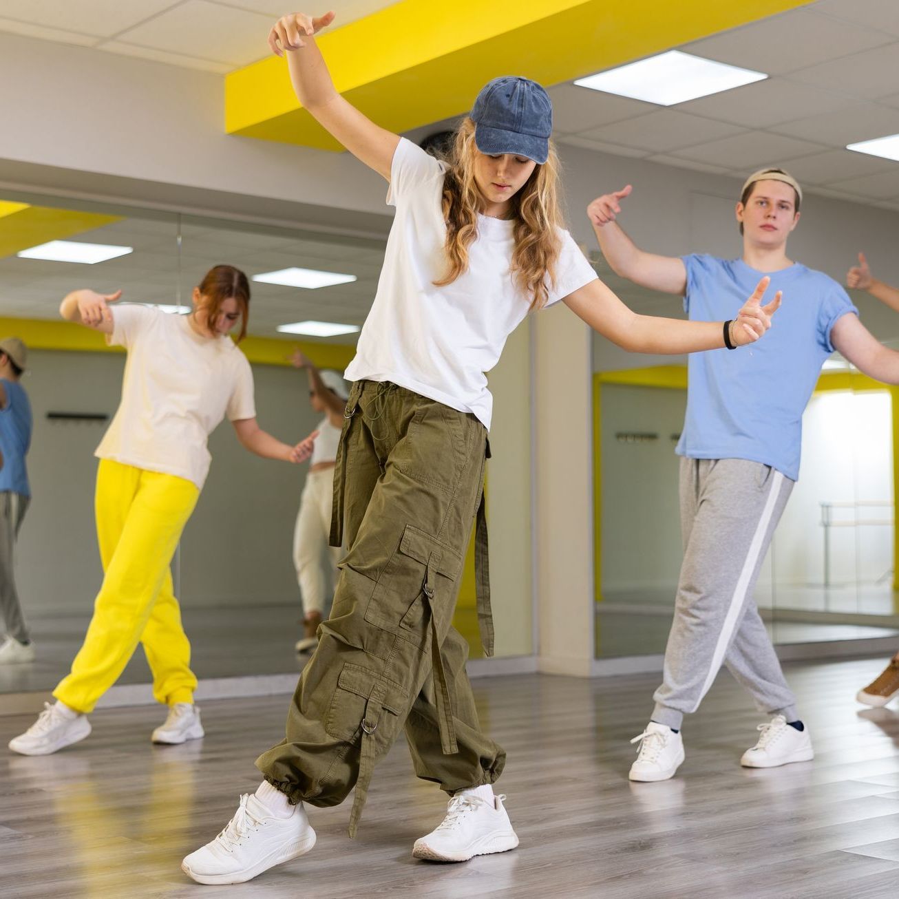 A group of young people are dancing in a dance studio.