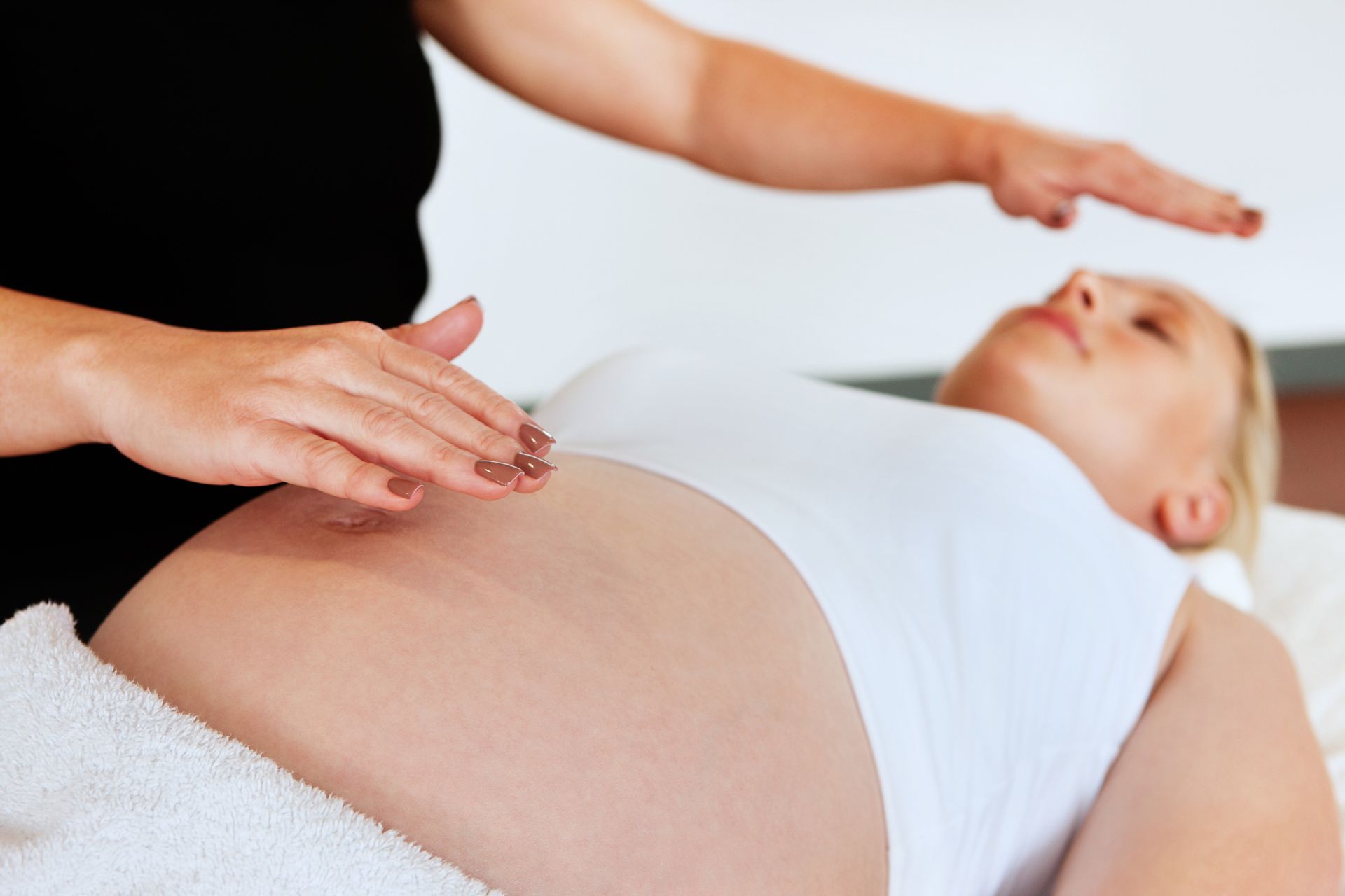 A woman is getting a head massage at a spa.