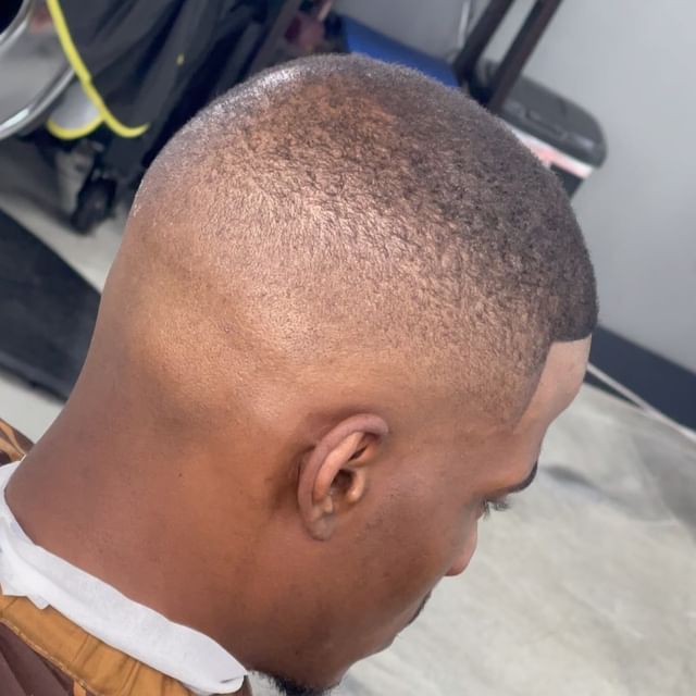 A close up of a man 's head with a shaved head