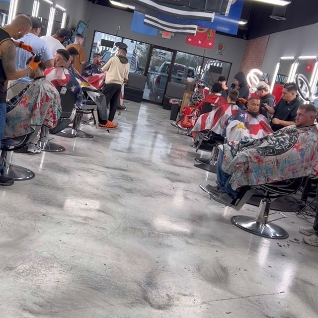 People are getting their hair cut at a barber shop
