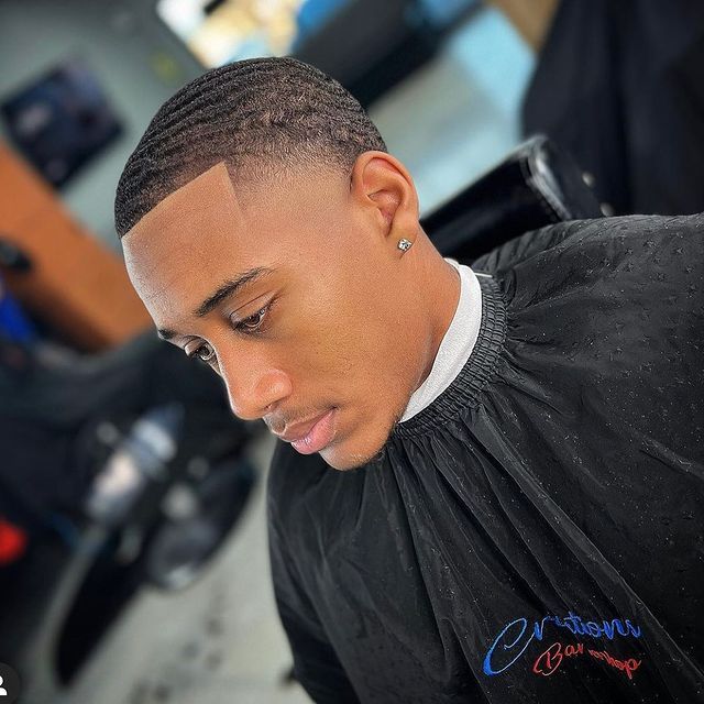 A man is getting his hair cut at a barber shop