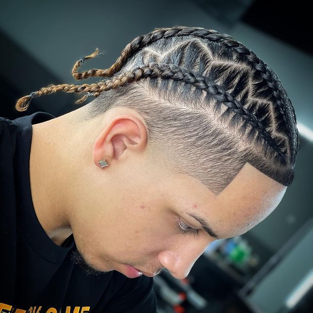 A man wearing a black shirt with the word game on it