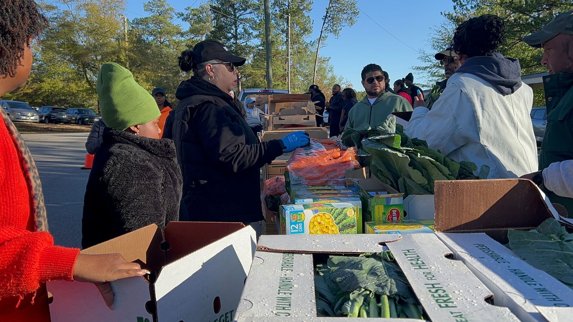 Volunteers prepare to hand out fresh produce to families at a Food From the Heart event.