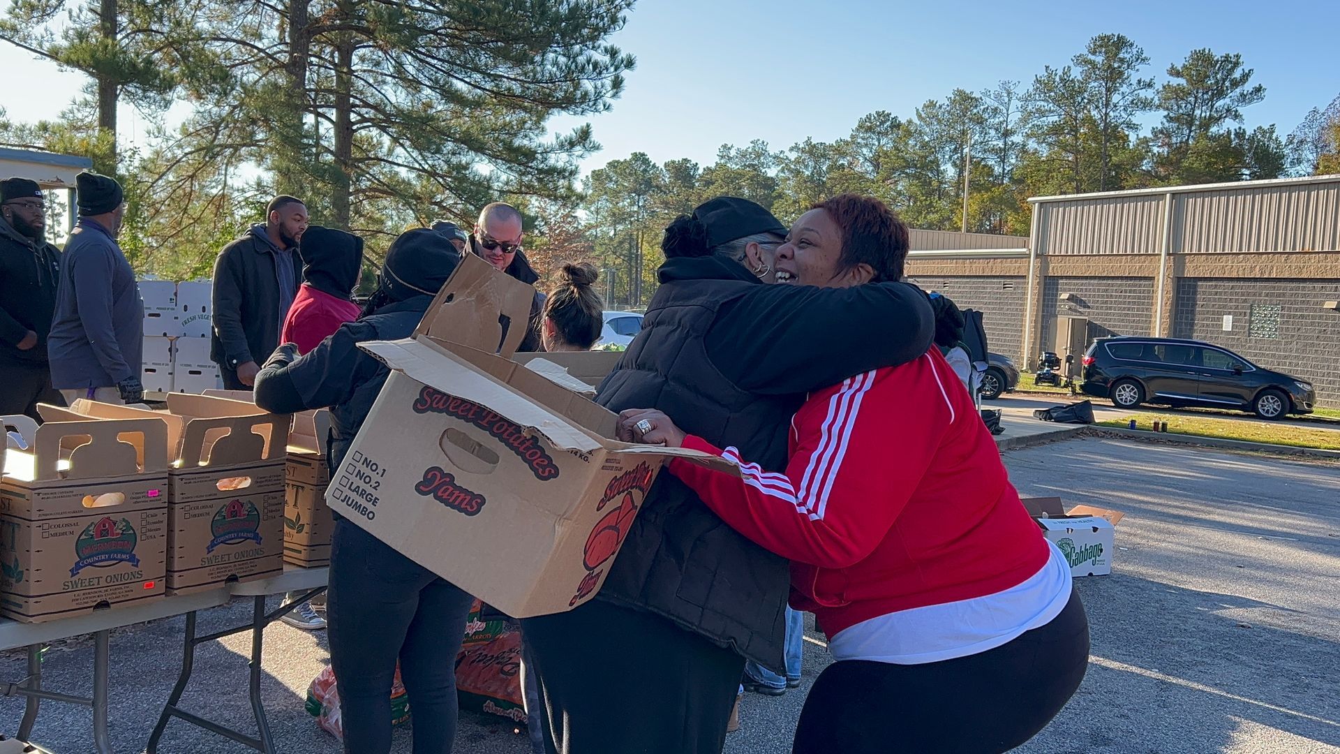 LCD's Tanya Rodriguez-Hodges embraces a friend at a Food From the Heart event.