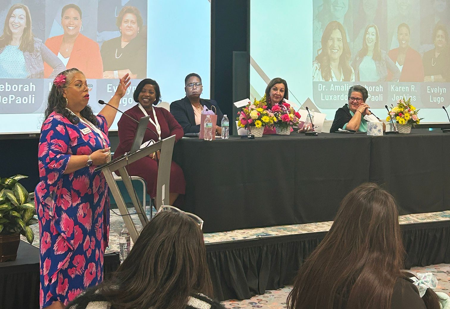 Tanya announces the panelists for a discussion moderated by Darci Strickland.