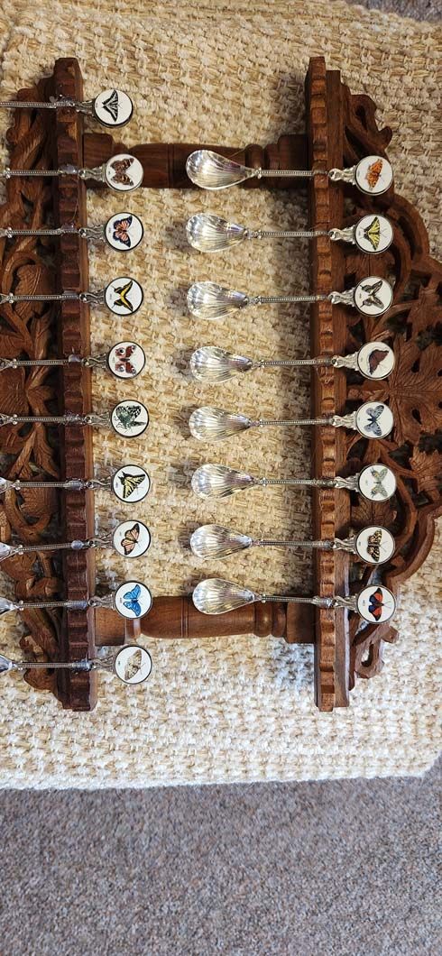 Wooden spoon rack with decorative spoons.