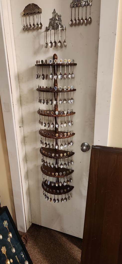 Jewelry display on a white wall, showcasing various hanging pieces.