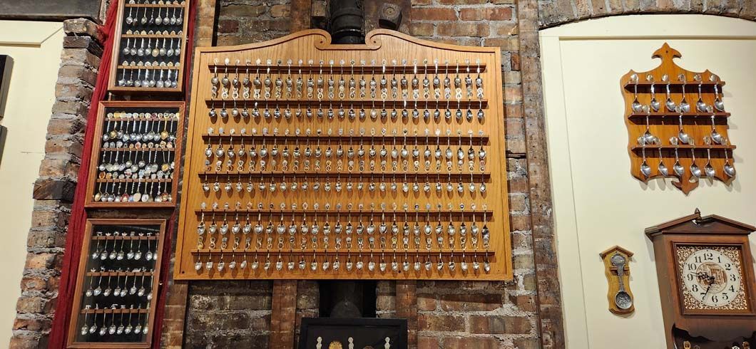 Wooden key racks on brick and cream walls, holding numerous keys. 