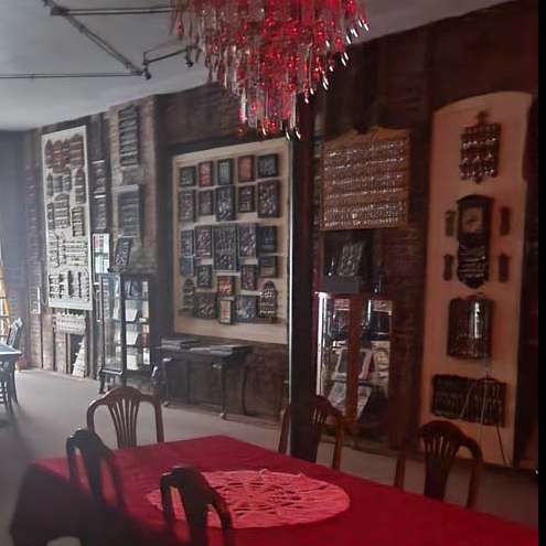 Room with red table and chairs. 
