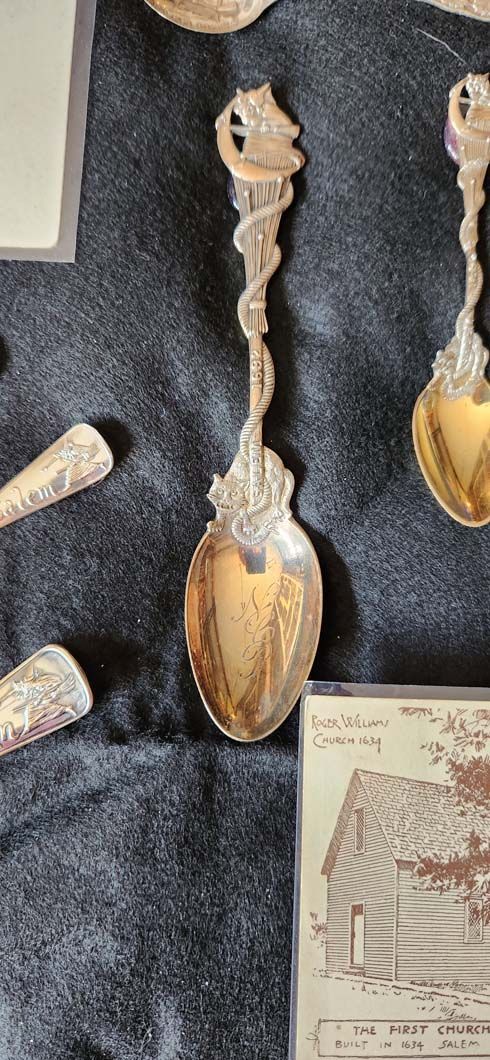 Silver spoon with ornate handle and bowl.