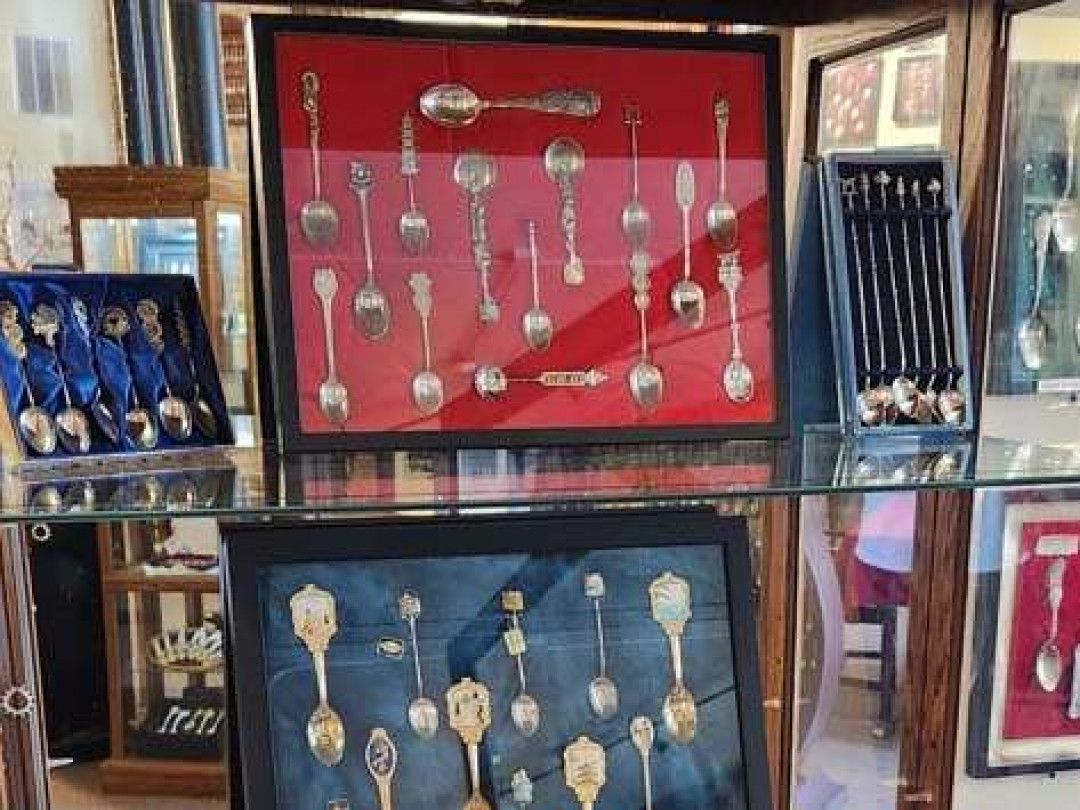 Display case of antique spoons.
