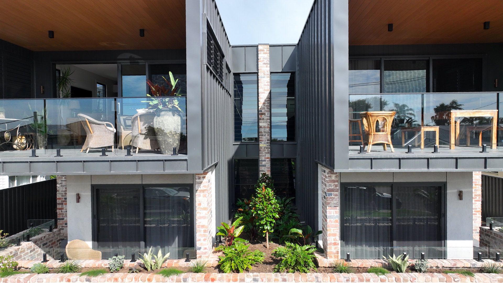 A modern apartment building with a lot of windows and balconies.