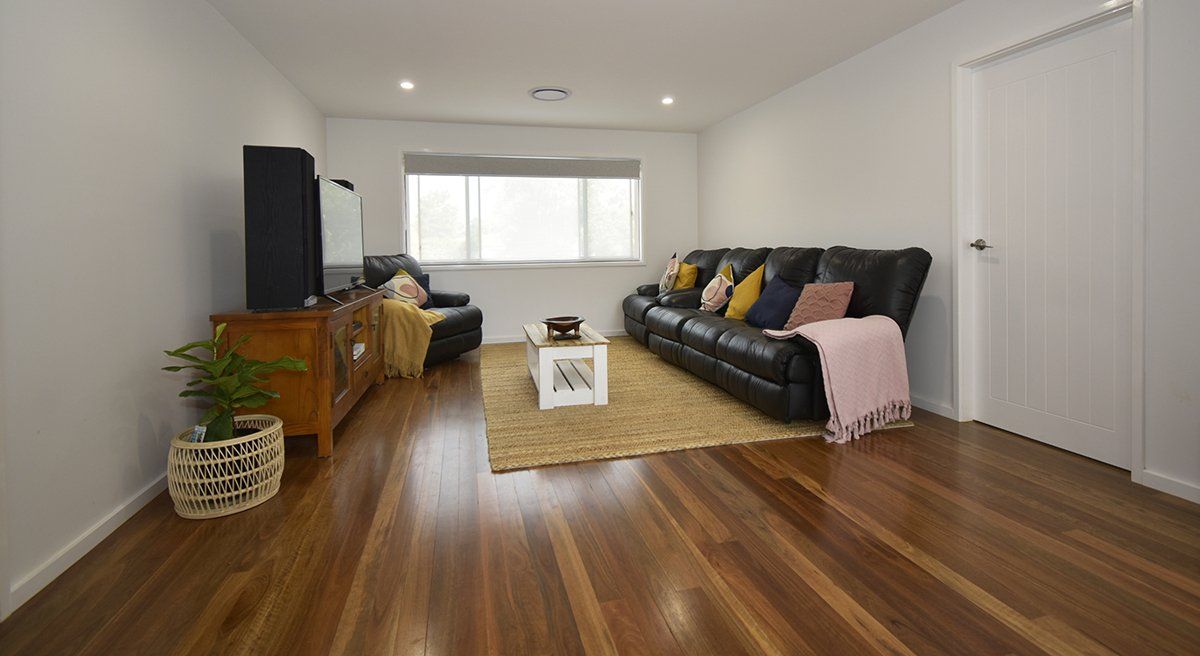 A living room with hardwood floors and a couch.