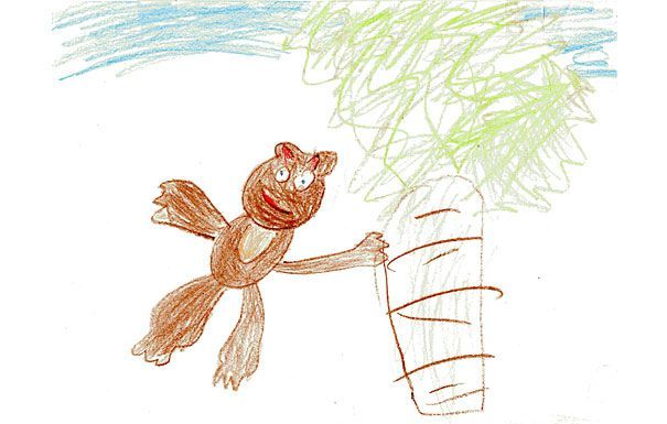 Brown monkey reaching for a tree, blue sky background.