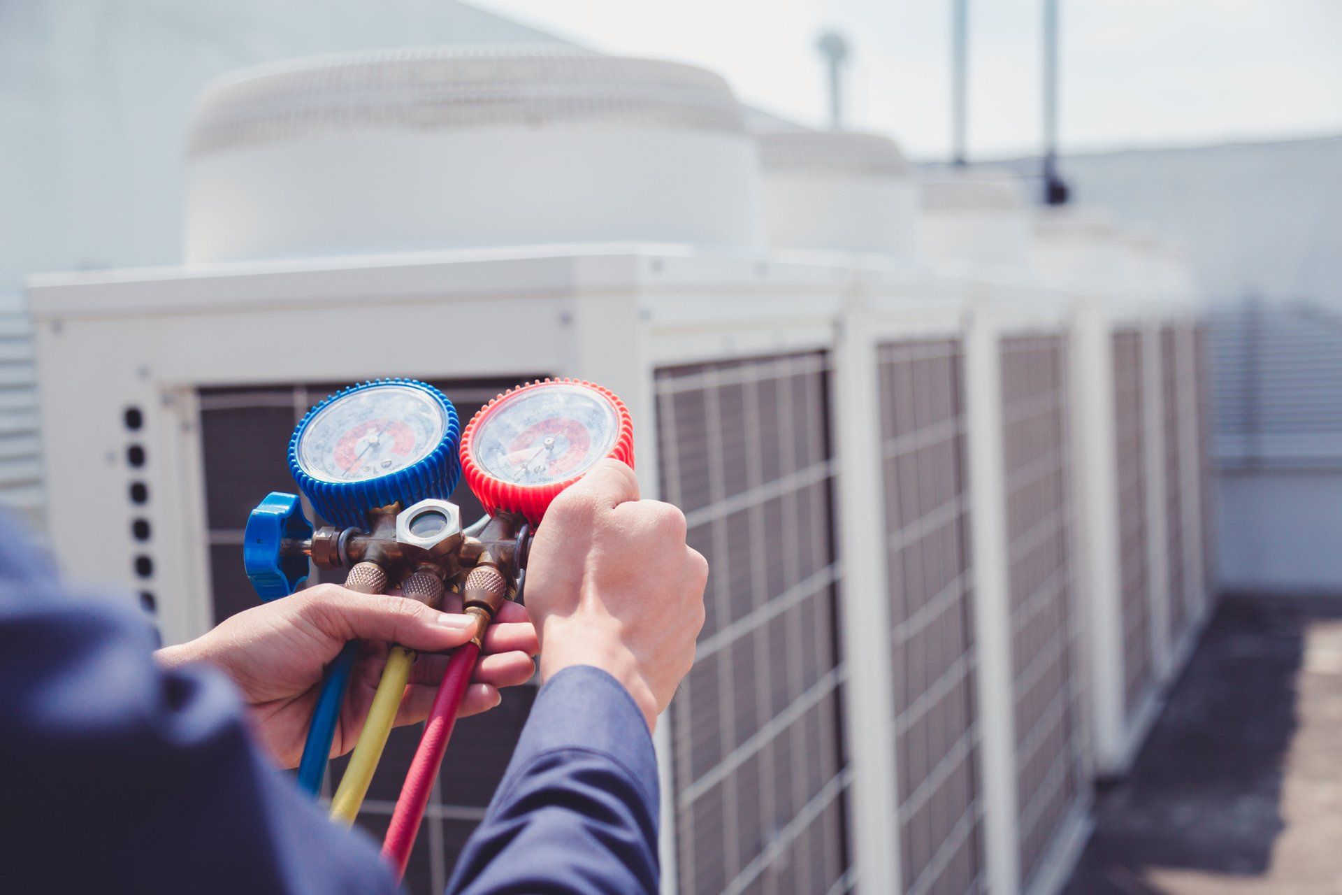 Technician Is Checking Air Conditioner — Flagstaff, AZ— Intermountain Plumbing & Mechanical