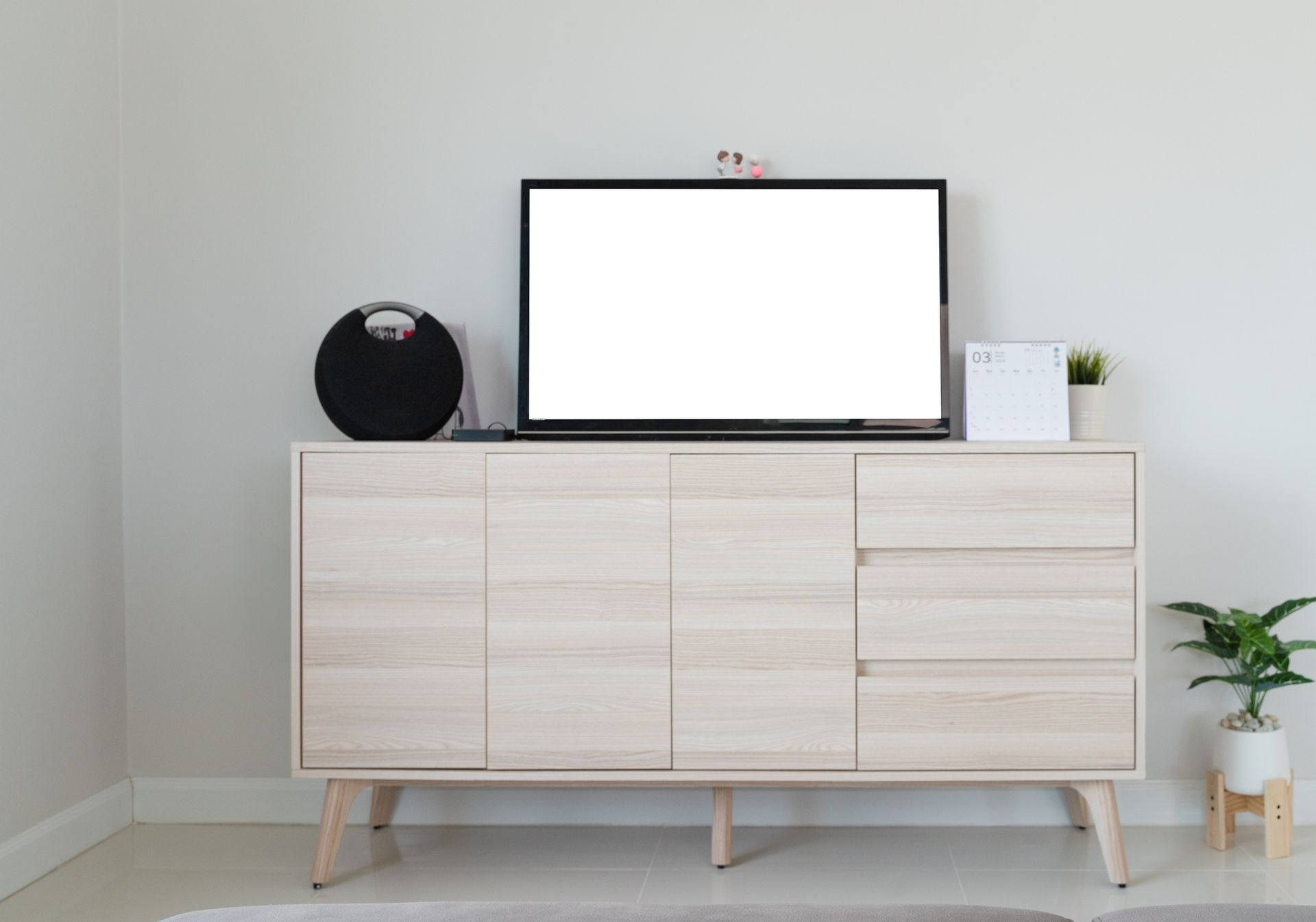 A flat screen tv is sitting on top of a wooden dresser in a living room.