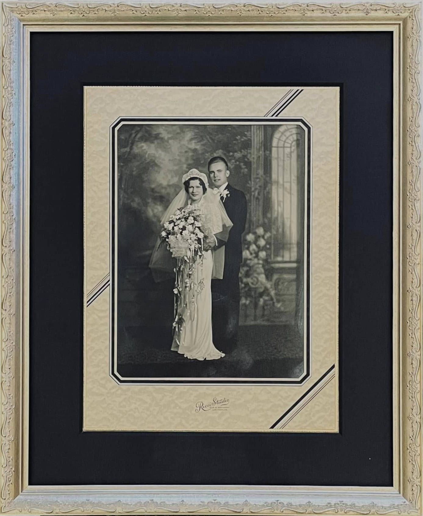 A black and white photo of a bride and groom in a frame