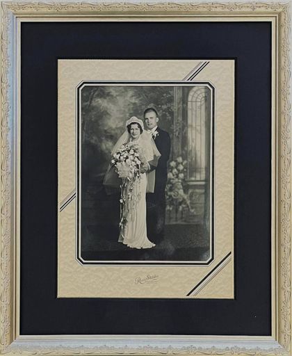A black and white photo of a bride and groom in a frame