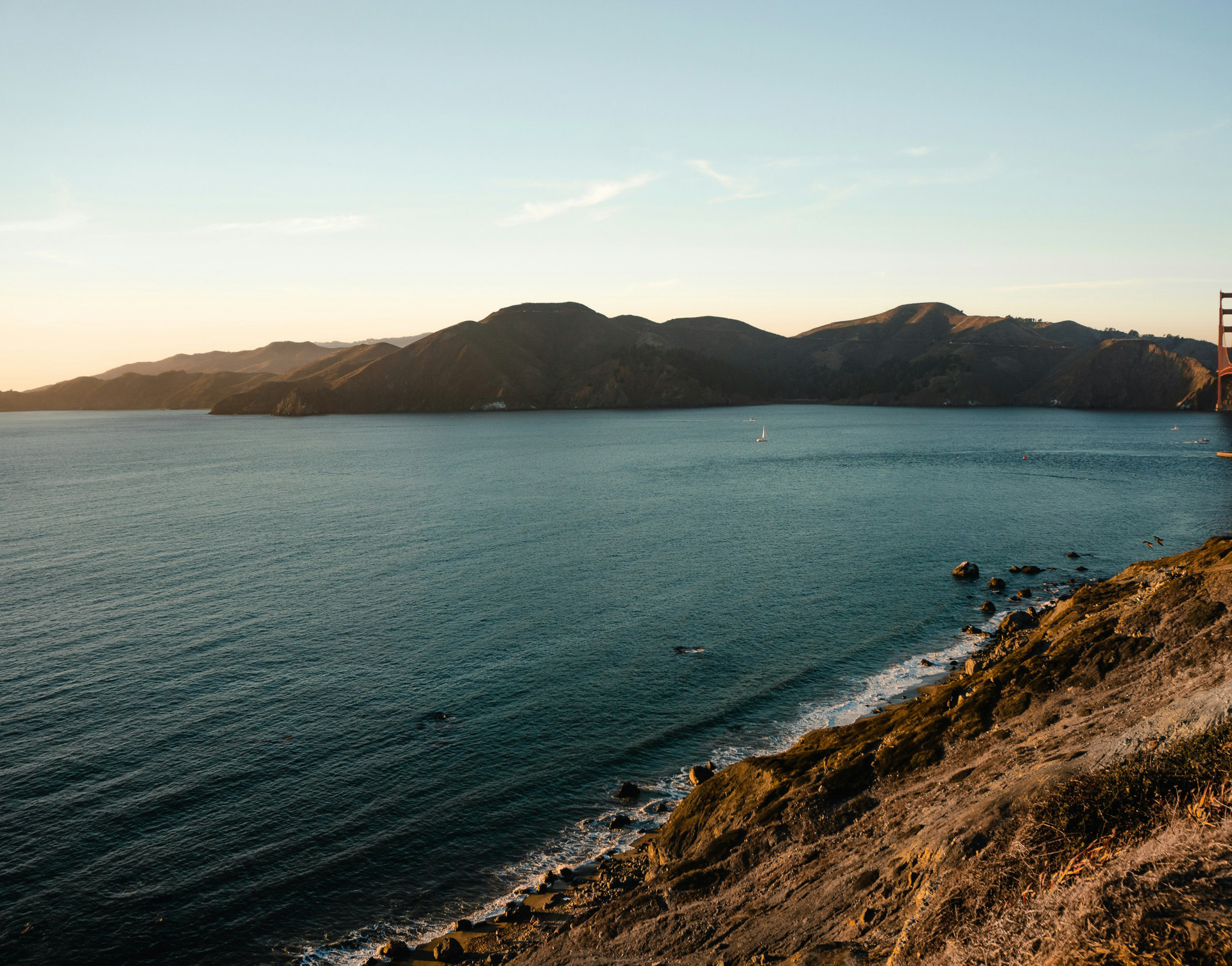 A large body of water with mountains in the background