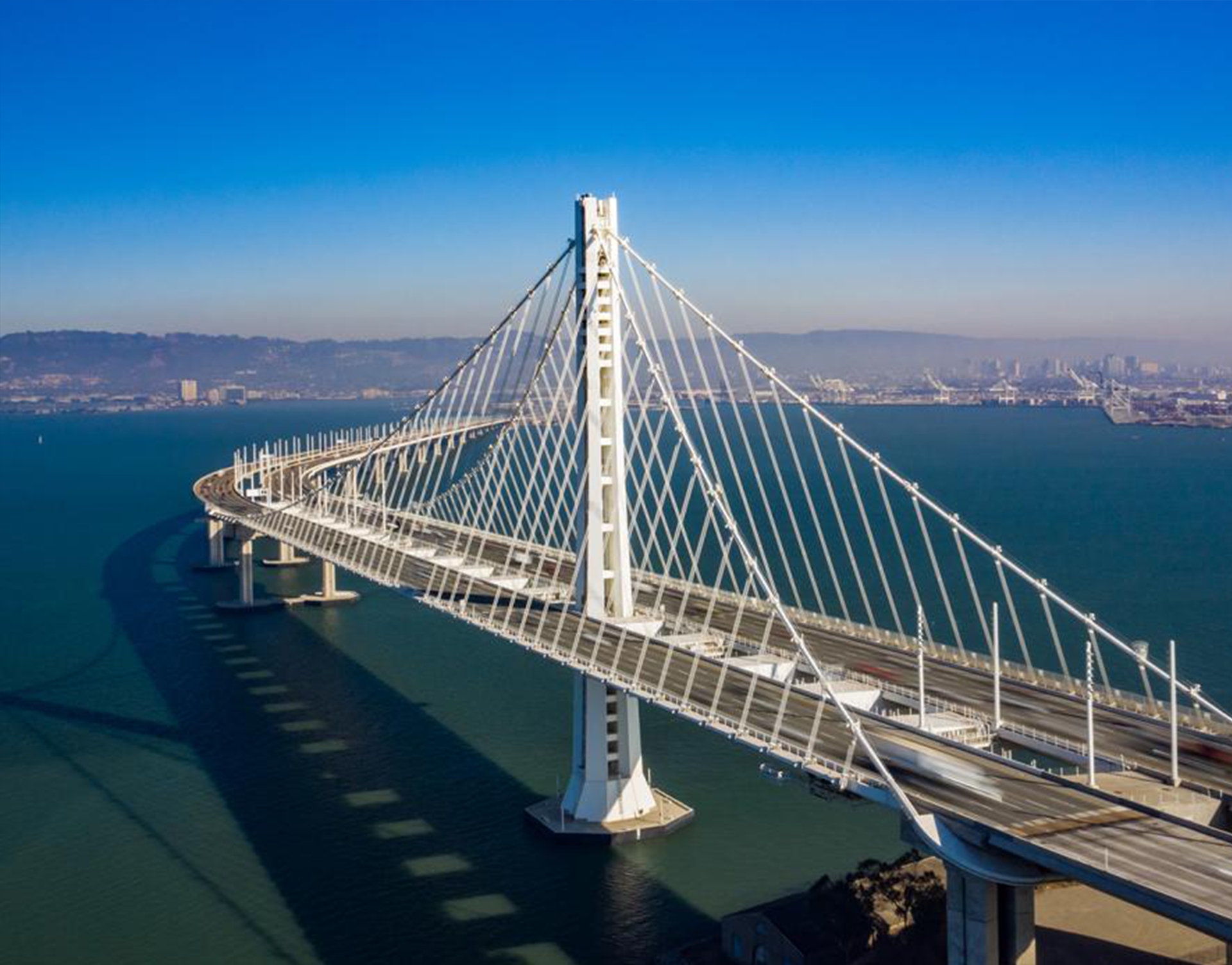 An aerial view of a bridge over a body of water.