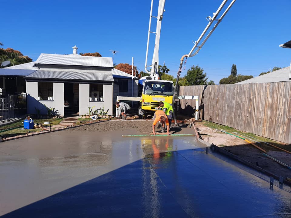 Worker levelling new concrete slab — Gallery in Townsville, QLD
