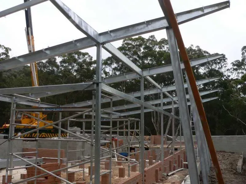 A Building Under Construction With A Crane In The Background — BM Steel Fabrication In Forster, NSW