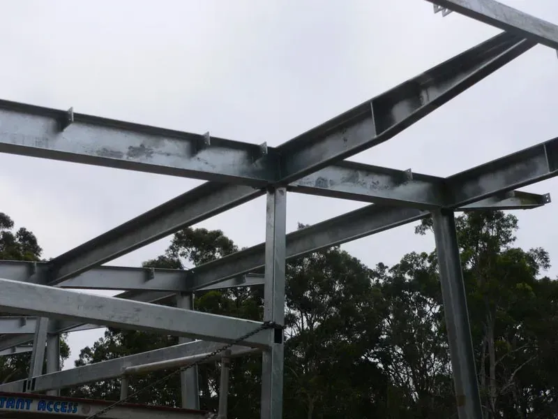 A Metal Structure Is Being Built With Trees In The Background — BM Steel Fabrication In Forster, NSW
