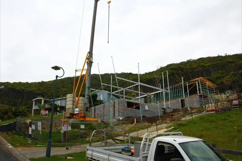 A White Truck Is Parked In Front Of A Building Under Construction — BM Steel Fabrication In Forster, NSW