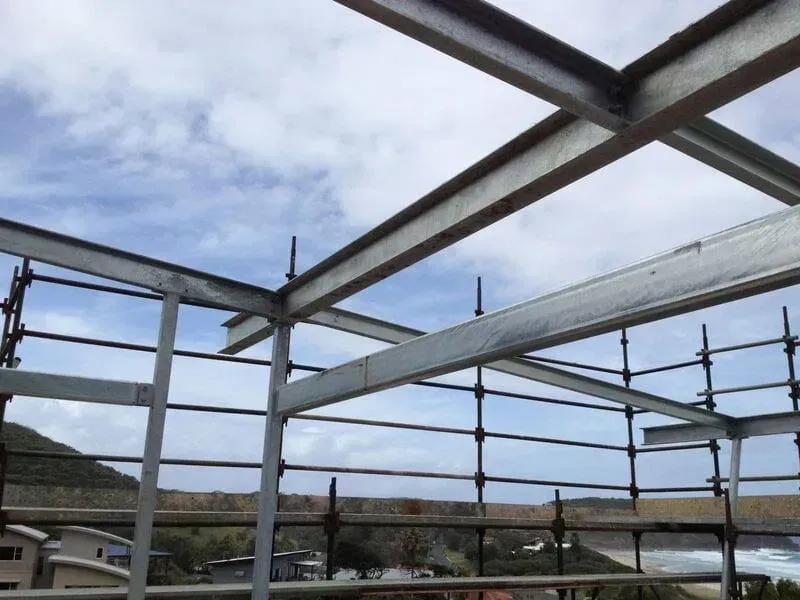 A Building Under Construction With Scaffolding And A Blue Sky In The Background — BM Steel Fabrication In Forster, NSW