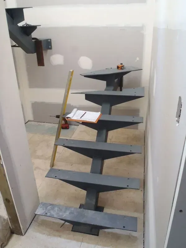 A Metal Staircase Is Being Built In A Room — BM Steel Fabrication In Forster, NSW