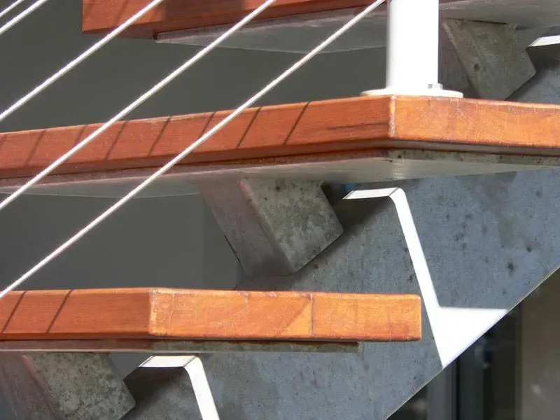 A Staircase With Wooden Steps And A White Railing — BM Steel Fabrication In Forster, NSW