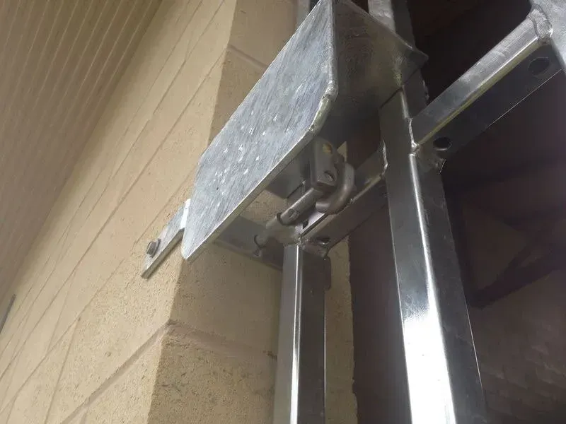 A Metal Structure Is Attached To A Brick Wall — BM Steel Fabrication In Forster, NSW