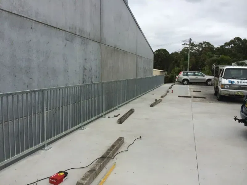 A White Van Is Parked In A Parking Lot Next To A Building — BM Steel Fabrication In Forster, NSW