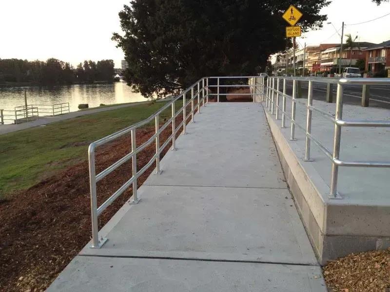 A Ramp With A Metal Railing Leading To A River — BM Steel Fabrication In Forster, NSW