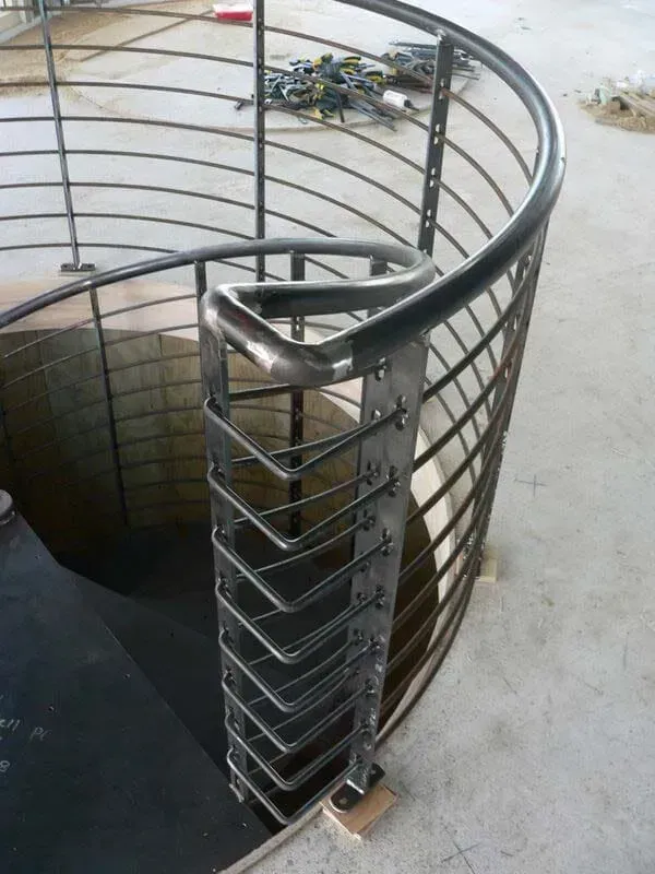 A Spiral Staircase With A Stainless Steel Railing — BM Steel Fabrication In Forster, NSW
