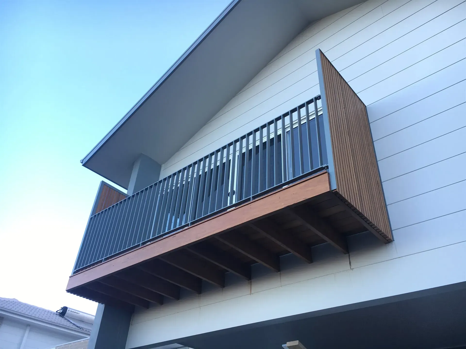 A Balcony On The Side Of A Building With A Blue Sky In The Background — BM Steel Fabrication In Forster, NSW