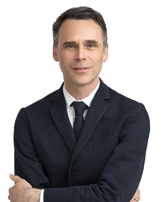 A man in a suit and tie with his arms crossed