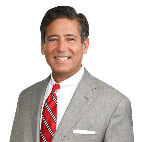 A man in a suit and tie is smiling for the camera.