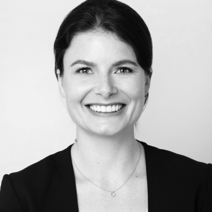 A woman is smiling in a black and white photo