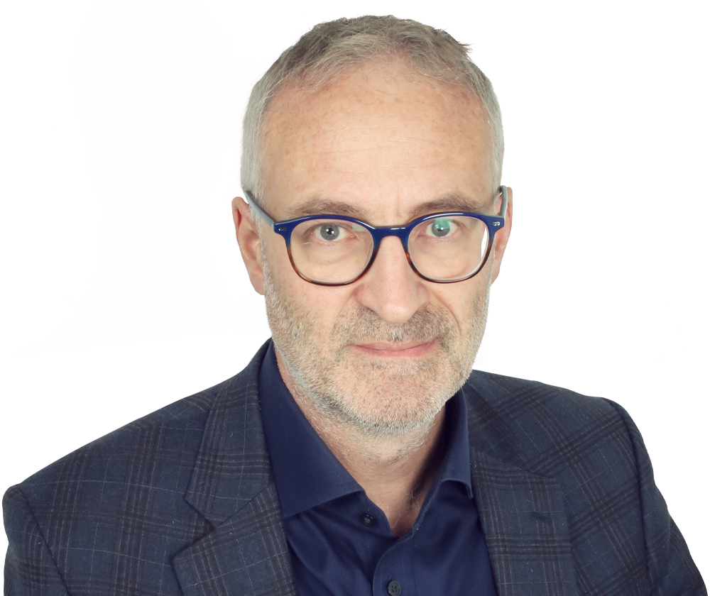 A man wearing glasses and a suit is looking at the camera