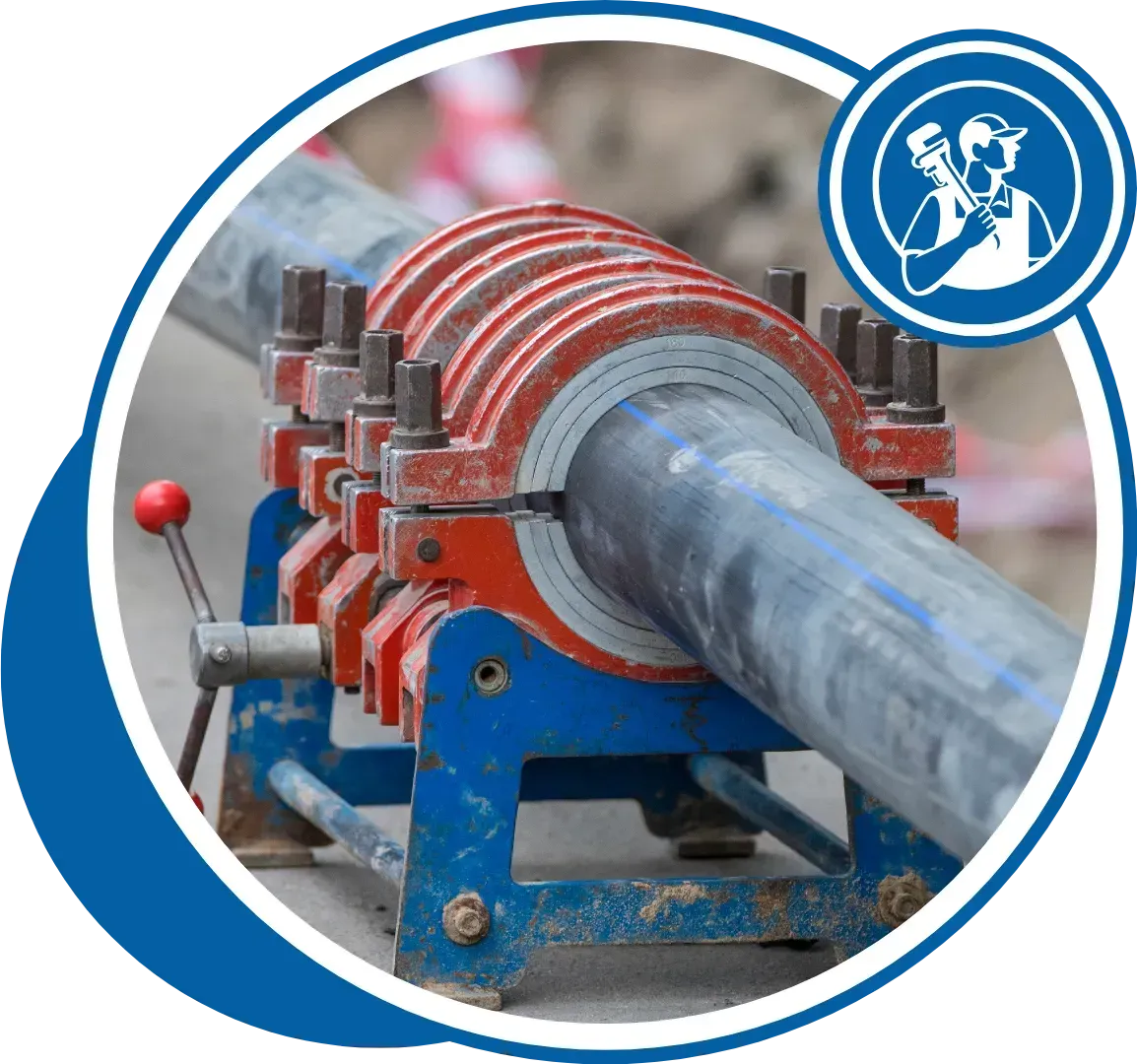 A blue and red pipe fusion machine welding a large black pipe, outdoors.