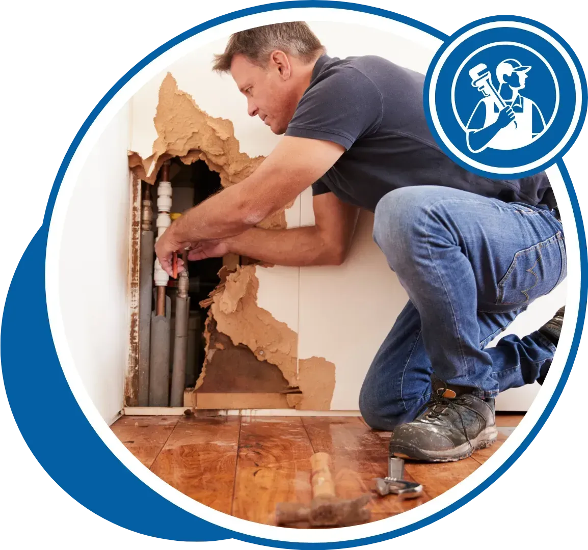 Plumber fixing pipes in a damaged wall; wearing jeans and work boots. Blue and white circular icon.