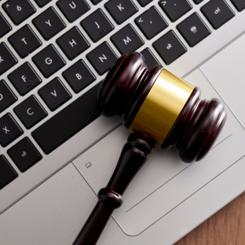 Gavel on a laptop keyboard, suggesting online legal or auction concept.