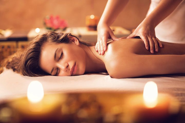 Young woman relaxing during back massage — Springfield, Il — Reset Spa