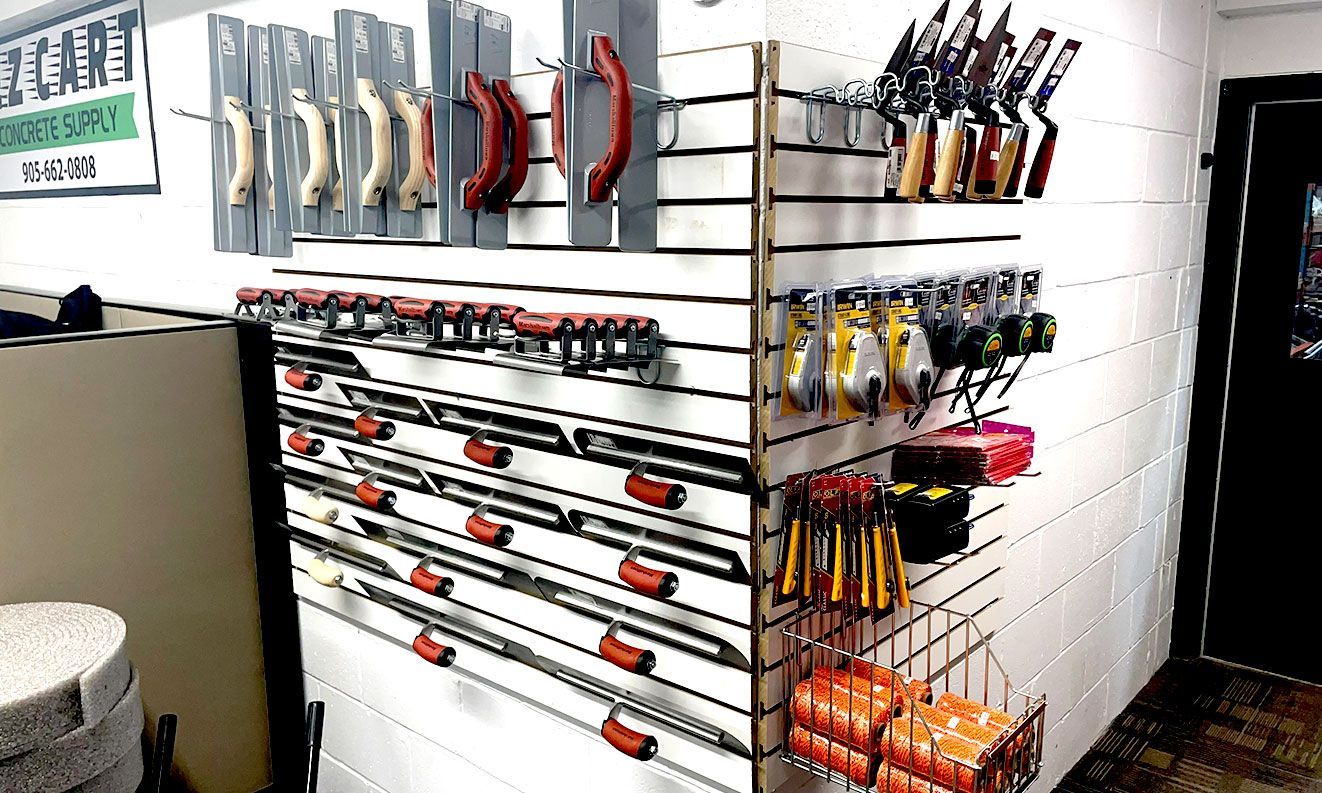 A bunch of tools are hanging on a wall in a store.