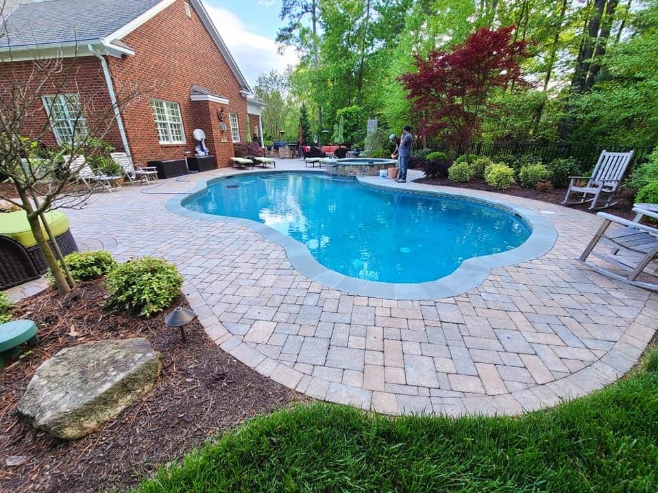 There is a Large Swimming Pool in the Backyard of a House