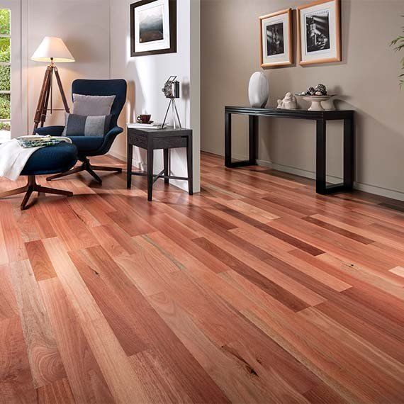 A living room with hardwood floors and a blue chair