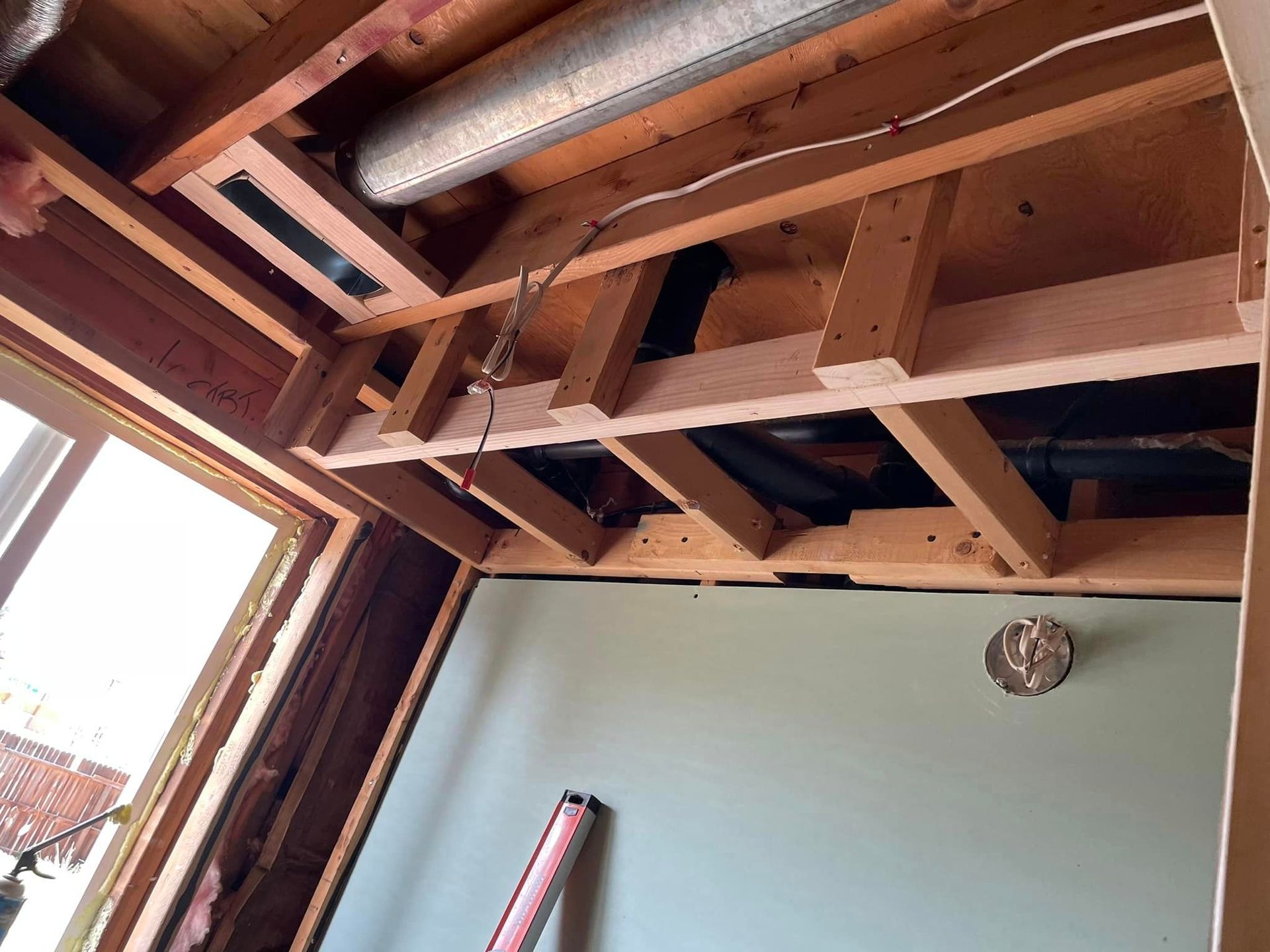 A room with a wooden ceiling and a window