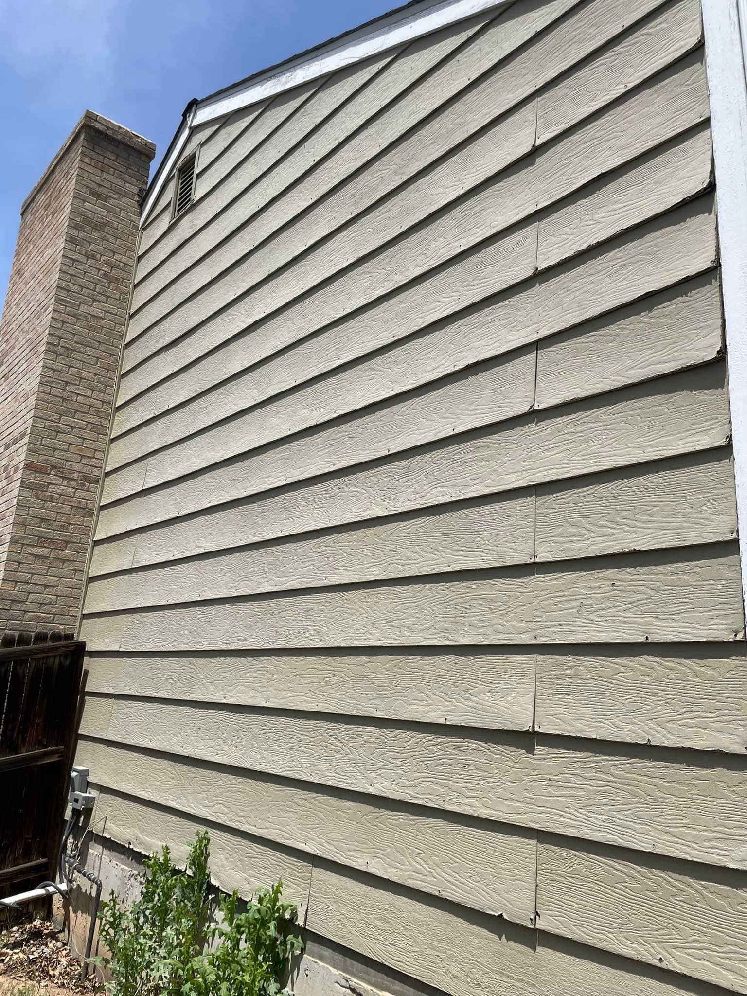 A house with a brick chimney on the side of it.